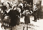 Foto des Jungen aus dem Warschauer Ghetto. Der namensgebende Junge ist mittig im Vordergrund zu sehen.