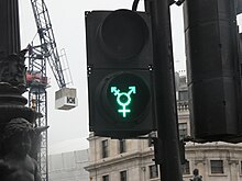 A pedestrian traffic light in Trafalgar Square, London with the [?] symbol, installed for the 2016 Pride in London Transgender symbol [?] on a trafic light in Trafalgar Square.jpg
