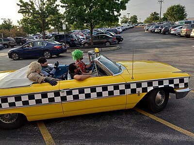 People in a Crazy Taxi car at TooManyGames 2023