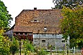 Wohnstallhaus und rechtwinklig angrenzende Scheune eines Bauernhofes