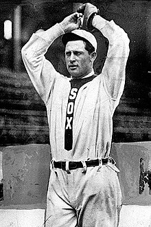 A man in a light baseball uniform and cap