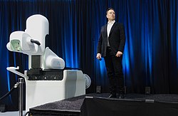 Elon Musk premiering the surgical robot that implants the Neuralink brain chip Elon Musk and the Neuralink Future.jpg