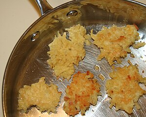 English: Latkes (potato pancakes) frying in ol...