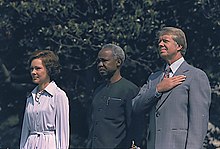 The Carters and Julius Nyerere standing next to each other outside.