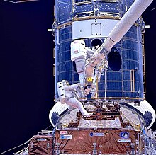 Astronauts Musgrave and Hoffman install corrective optics during SM1 Upgrading Hubble during SM1.jpg