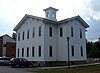 Academy Hall, a wooden, white building topped with a square cupola