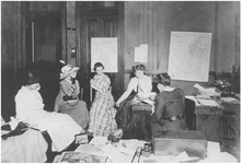 Black and white photo of a group of women during a strategy session for women's suffrage