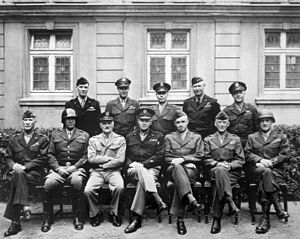 Patton (seated, second from left) and Eisenhower (seated, middle) with other American military officials, 1945.