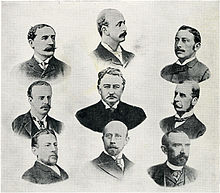 Литография конца XIX века, изображающая головы и плечи девяти мужчин в три ряда. Мужчина в центре, кажется, был намеренно сделан более заметным, чем другие, казался крупнее и сильнее нарисован.