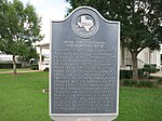 Photo shows a Texas Historical Commission marker for the former Sugar Land Independent School District on the grounds of the Sugar Land Auditorium. It became part of the Fort Bend Independent School District in 1959. View is toward the southeast.