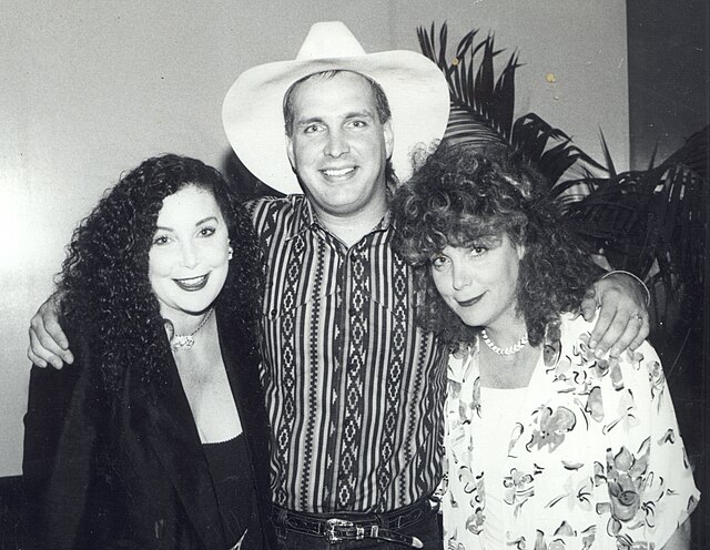 Singer Garth Brooks posing with two women