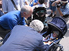 NDP leader Jack Layton and Bloc Quebecois leader Gilles Duceppe greet babies - a traditional campaign activity - at the Fete nationale du Quebec in Montreal Layton and Duceppe baby-kissing.jpg