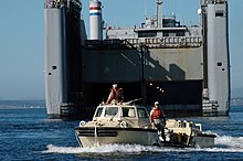 US Navy Seabees from Beachmaster Unit One (BMU-1) operate a LARC-V, launching from a Military Sealift Command (MSC) sea barge heavy lift ship SS Cape Mohican (T-AKR-5065) US Navy 050728-N-8268B-022 A Logistical Amphibious Recovery Craft (LARC) amphibious vehicle assigned to Beachmaster Unit One (BMU-1) launches from the Military Sealift Command (MSC) sea barge heavy lift ship SS Cape Mohican (T.jpg