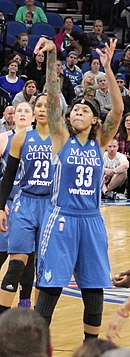 Seimone Augustus of the Minnesota Lynx shoots a goal in the 2016 WNBA Finals at Target Center. At left are Lindsay Whalen and Maya Moore. Augustus 20161011.jpg