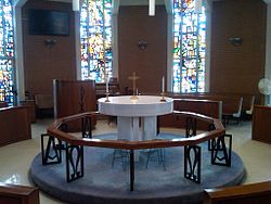 Two altar candles adorn the altar table of a Methodist chapel in Kent, Ohio, United States Kent UMC chapel.jpg
