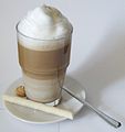 A glass of Latte macchiato with biscuits
