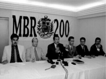 A 1997 image of MBR-200 members meeting (Nicolas Maduro is seen on the far left while Chavez is seen speaking in the center) MBR-200 meeting.png