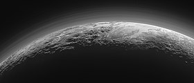 Panoramic view of Pluto's icy mountains and flat ice plains, imaged by New Horizons 15 minutes after its closest approach to Pluto. Distinct haze layers in Pluto's atmosphere can be seen backlit by the Sun. MVIC sunset scan of Pluto.jpg