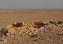 A sangar (fortification) from the Western Sahara conflict. The fortification is built of rocks on top of a mesa overlooking the Grart Chwchia, Al Gada, Western Sahara. The Sangar is facing north and was probably built by the Sahrawis in the 1980s. Sangar western sahara.jpg