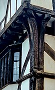 image of the corner timbers of the House That Moved, with three distinct timbers splaying out and supporting the dragon beam, which is a diagonal horizontal beam, with an overhang on two sides