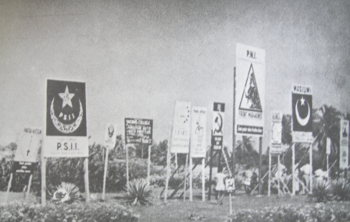 Various large election-campaign posters of participating political parties, with their symbols (amongst many, the PSII, the PNI, the PKI and Masjumi) on display in the run-up to the election. 1955 Indonesian Election Posters.png