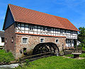 A watermill uses the force of running stream or river water to turn heavy stone grinding surfaces