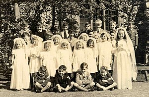 Group portrait of children at their First Comm...