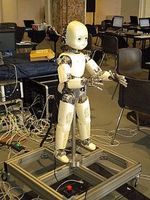 An open source iCub robot mounted on a supporting frame. The robot is 104 cm high and weighs around 22 kg. Icub full body.JPG