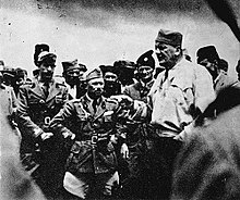 A tall male Chetnik amongst a group of men dressed in Italian Army uniform
