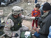 American medic tends to some minor injuries after two car bombs exploded Nov. 18, 2005 near a residential area in Baghdad.