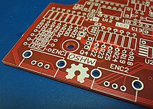 The OSHW (Open Source Hardware) logo silkscreened on an unpopulated PCB Open Source Hardware (OSHW) Logo on blank PCB.jpg