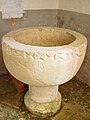 Baptismal font in a corner at the back of the church