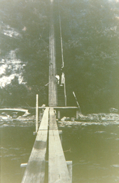 Photo of stairs and lift ramp running from the Elk River floating dock, up the bluff, to the Turkey Point Light Station. Two unidentified people are standing at the stairs.