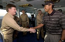 Woods visiting aircraft carrier USS George Washington (CVN-73) in the Persian Gulf before participating in the 2004 Dubai Desert Classic US Navy 040303-N-5319A-001 Tiger Woods meets Commander Carrier Group Eight (CCG-8) Rear Adm. Denby H. Starling II, on the flag bridge aboard the aircraft carrier USS George Washington (CVN 73).jpg