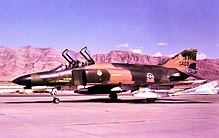 The Las Vegas Range of mountains is visible beyond a 66th FWS F-4E on the Nellis tarmac. 66th Fighter Weapons Squadron - McDonnell Douglas F-4E-38-MC Phantom 68-0400.jpg