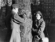 A Canadian Women's Army Corps member and a man in the Canadian Air Force chalk hearts on a tree on Valentine's Day 1944 CWAC Valentine's Day 1944 (4112917253).jpg