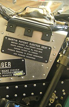 The plate of the Martin ejector seat of a military aircraft, stating that the product is covered by multiple patents in the UK, South Africa, Canada and pending in "other" jurisdictions. Dubendorf Museum of Military Aviation. Ejector seat with patents cropped.jpg