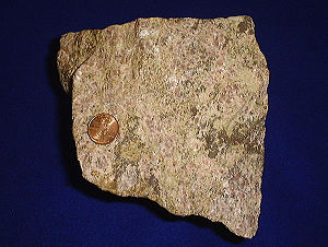 Rare earth ore, shown with a United States pen...