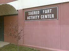 An example of grafitti where a sign has been edited to spell the word "fart". Grafitti and farting are widely considered to be rude, but this rudeness is often seen as having comic potential. Sacred Fart Activity Center.jpg