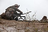 A U.S. Marine initiating a barrel change of the M240B.