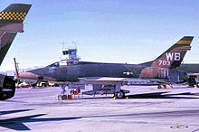 The Nellis control tower behind a 4536th F-100D ("WB" tail code). In July 1968 the first tail codes appeared on Nellis-based aircraft: "WC" (4537th F-105), "WD" (4538th F-4C), & "WF" (4539th F-111). 4536th Fighter Weapons Squadron - North American F-100D-30-NA Super Sabre 55-3703.jpg