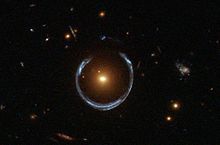 A luminous red galaxy (LRG) acting as a gravitational lens, distorting the light from a much more distant blue galaxy into an Einstein ring A Horseshoe Einstein Ring from Hubble.JPG