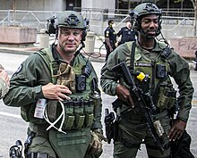 Atlanta Police SWAT (special weapons and tactics) officers overseeing a demonstration during the George Floyd protests. Atlanta Police Department officers detail from- Talking to Local Law Enforcement Georgia National Guard (cropped).jpg