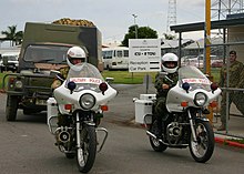Australian Army Land Rover and two military police motorcycles Australian Perentie Land Rover and MP motorcycles.jpg