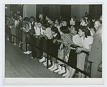 A crowd of roller skaters watch an exhibition in Chicago in 1939. Crowds watching roller-skating exhibition, Chicago, Illinois.jpg