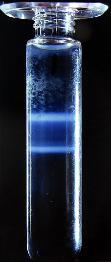 Caesium chloride (CsCl) solution and two morphological types of rotavirus. Following centrifugation at 100 g a density gradient forms in the CsCl solution and the virus particles separate according to their densities. The tube is 10 cm tall. The viruses are the two "milky" zones close together. CsCl density gradient centrifugation.jpg