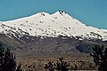 Llaima volcano with a blanket of snow covering its solidified lava flows