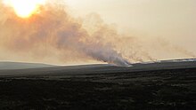 Muir burn in UK showing smokestack