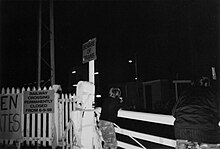A historical level crossing at night.