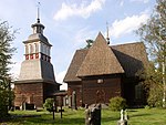 Petäjävesi Old Church, bell tower on the left, a cemetery in front.